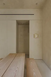 Modern minimalist interior featuring wood and concrete materials.