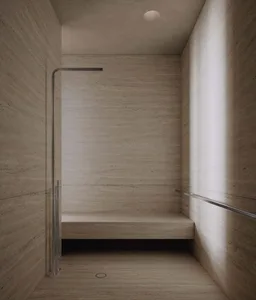 A minimalist bathroom with a concrete wall and floor, featuring a walk-in shower with a bench seat and minimalist fixtures.