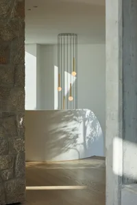 Modern entryway featuring concrete and stone textures.