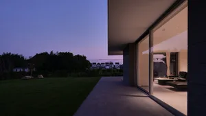 Modern house exterior featuring large glass windows.
