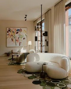 A modern living room featuring a textured cloth sofa, abstract wall art, and a sleek wooden shelving unit.