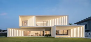 A modern residential exterior with concrete and glass elements.