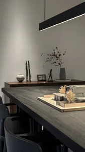 A modern workspace featuring wood, concrete, and metal materials