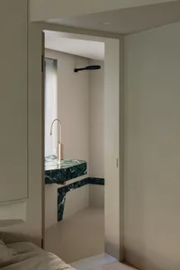 A minimalist bathroom featuring marble and concrete materials.