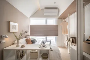 Modern minimalist bedroom featuring wooden furniture, fabric bedding, and metal accents.