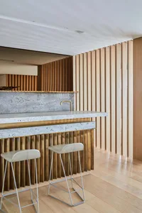 A modern residential kitchen featuring wood and brass accents.