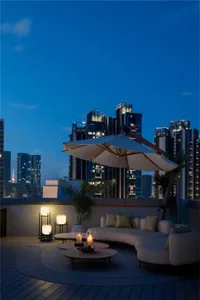 Modern rooftop deck with circular seating area, umbrella, and plants.