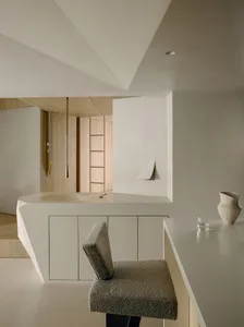Minimalist industrial interior with concrete walls and furniture.