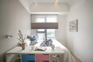 A minimalist bedroom with a white bed, white nightstand, and a small window with beige blinds.