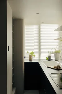 An elegant, minimalist kitchen with a granite countertop.