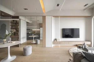 Modern minimalist living room featuring wood flooring, glass wall, and concrete elements.