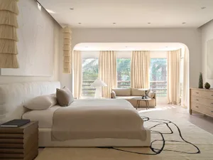A modern bedroom featuring a sofa and fabric elements.