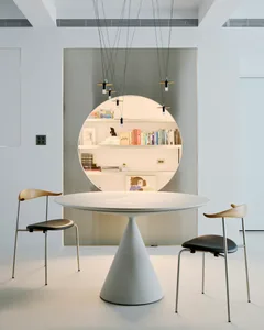 A modern living room with concrete flooring and minimalist decor