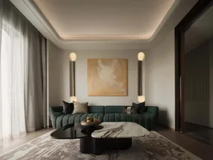 Modern living room with green vinyl sofa, marble coffee table, and abstract painting