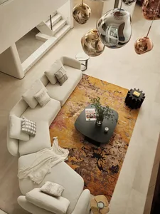 A modern living room with a white sectional sofa and a colorful rug.