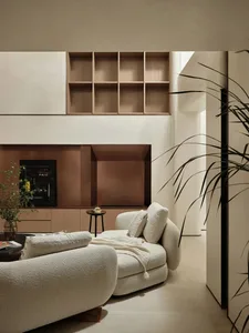 A modern interior design features a living room with neutral-toned leather textures.