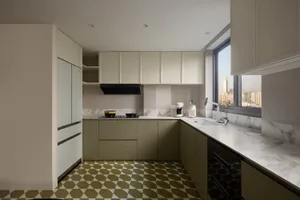 Modern kitchen with marble countertops, stainless steel appliances, and a view of the cityscape through the window.
