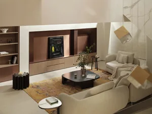 Modern minimalist living room with neutral-toned materials and furniture, featuring a large TV on the wall, comfortable sofas