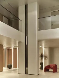 A modern lobby featuring concrete and glass materials.