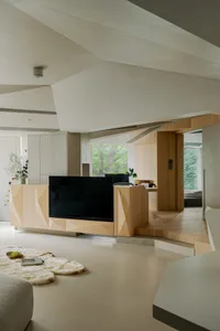 A modern minimalist living room featuring natural wood and concrete materials.