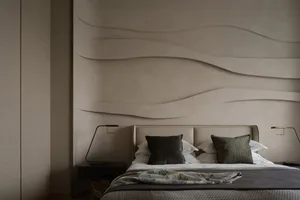 Modern bedroom with textured walls and minimalist decor.