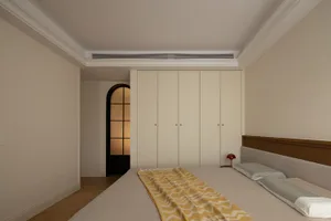 Modern minimalist bedroom with beige walls, wooden bed frame, and a yellow and white striped blanket.