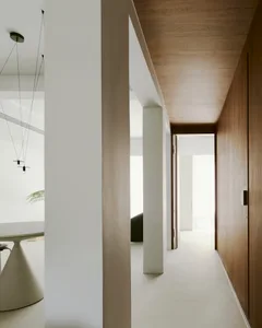 A modern residential interior with minimalist white design elements, featuring a clean, open floor plan and contemporary furn