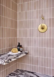 Modern bathroom featuring ceramic tile and marble accents.