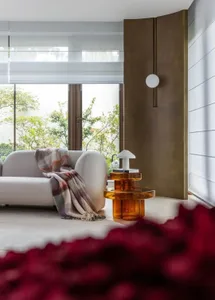 A modern living room featuring mixed materials and a cozy atmosphere.