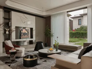 Modern living room featuring marble accent wall, leather seating, and glass coffee table