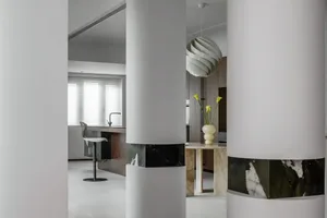 Modern kitchen featuring marble countertops and concrete flooring.
