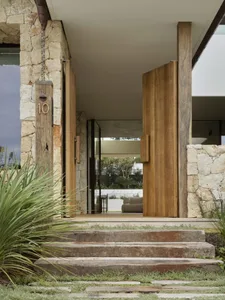 A modern minimalist entrance featuring stone and wood materials.