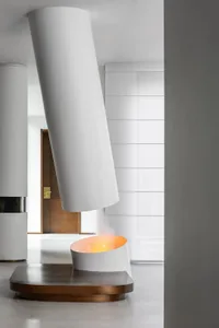 A sleek, minimalist modern fireplace with an industrial metal design.