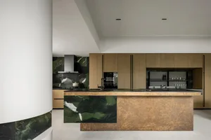 A modern residential kitchen featuring granite countertops and cabinets.
