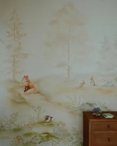 A painted mural in a children's room depicting a foggy forest scene with animals and plants.