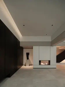 Modern minimalist interior with concrete walls and glass fireplace