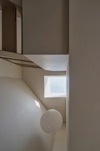 Minimalist interior design featuring a cement wall.