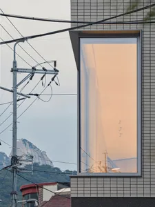 A modern building exterior featuring large glass panels.