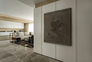 Modern living room featuring a metallic sculpture wall art.