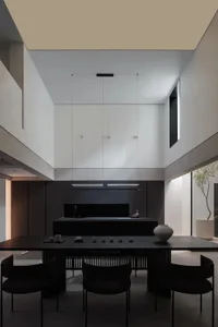 A modern kitchen features sleek concrete countertops and black metal cabinets.