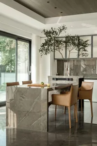 A modern kitchen with marble finishes and a minimalist design.