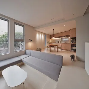A contemporary, neutral-color living space with a minimalist design and wood-texture accents.