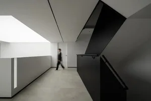 A modern office interior with concrete, glass, and metal elements
