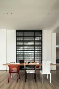 A modern office space featuring a wooden desk with various chairs.