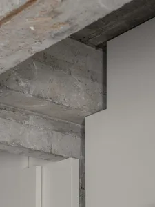 Industrial-style interior design featuring concrete walls and exposed beams