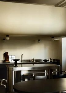 Industrial-style kitchen with metal finishes and minimalist design elements.