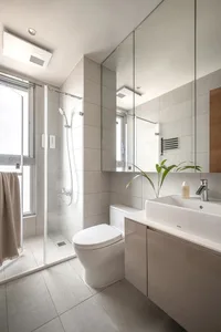 Modern minimalist bathroom featuring grey tiled walls and floor, a glass shower enclosure, and a floating vanity with a white