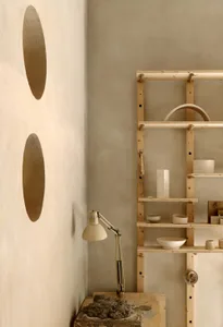 Minimalist ceramic workshop with wooden shelves and clay tools.