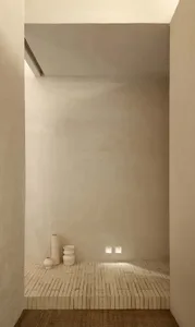 Minimalist interior featuring concrete and brick walls and flooring.