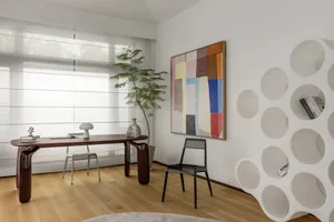 現代簡約室內空間，搭配木質餐桌與抽象牆面藝術作品。